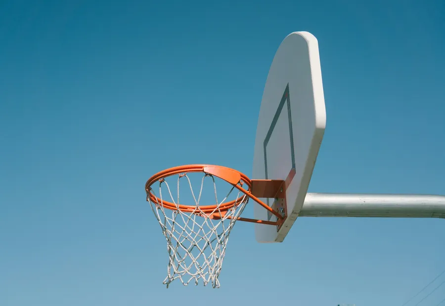 A basketball hoop against an open blue sky.